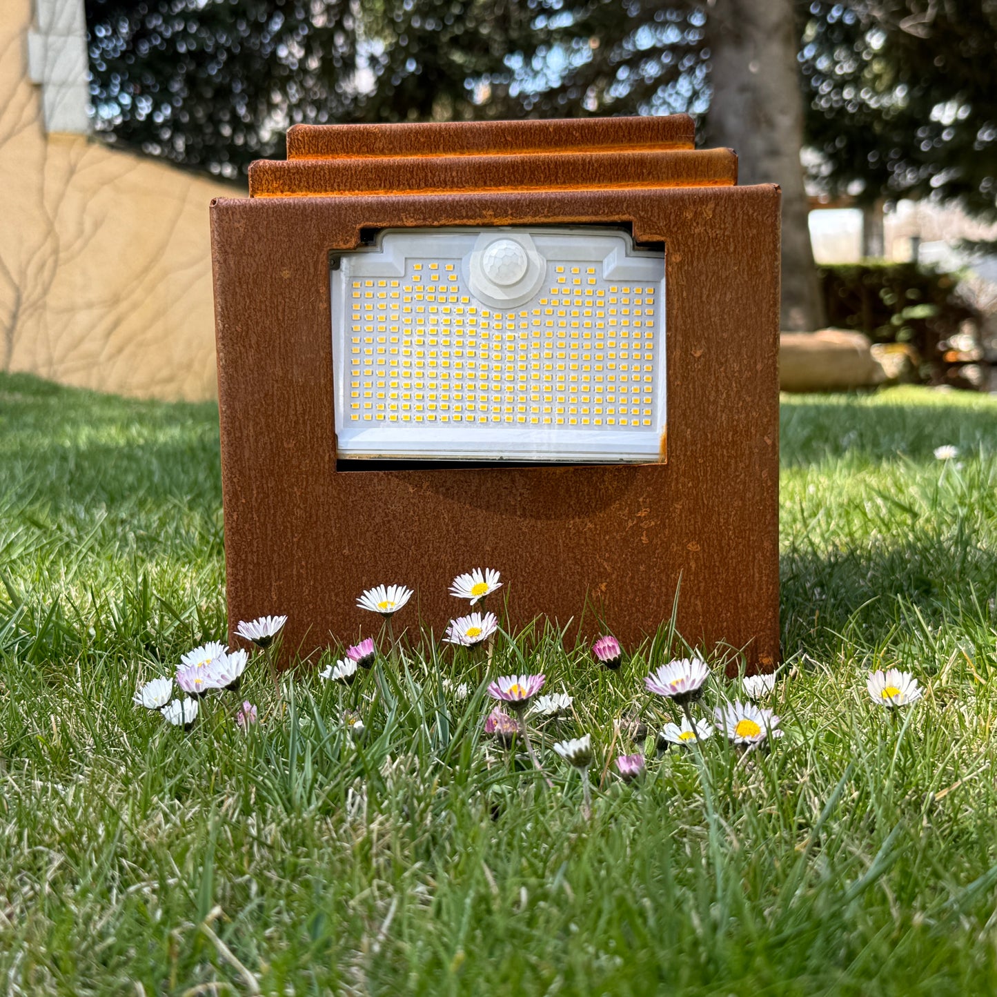 Natural rust Corten solar garden light. Powerful outdoor bollard or beacon with motion sensor. Wireless. Warm white light.